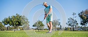 full length portrait of golfer in cap with golf club, sport