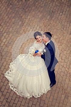 Full-length portrait of a gorgeous couple of bride and groom. The view from above. Full length photo