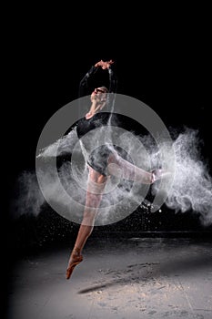 Full-length portrait of graceful slender ballet dancer woman jumping, dressed in bodysuit