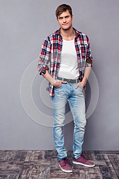 Full length portrait of handsome confident man in checkered shirt