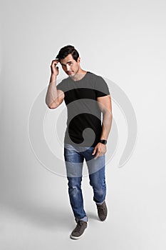 Full length portrait of handsome  man in casual clothes on grey background