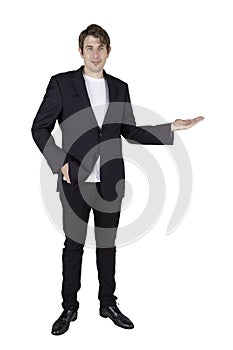 Full length portrait of handsome standing posing businessman and holding copy space on the palm and looking straight at the camera