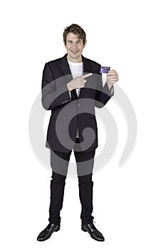 Full length portrait of handsome standing posing businessman holding credit card and looking straight at the camera
