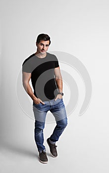 Full length  of handsome young man in casual clothes on grey background