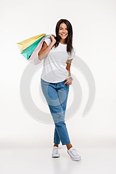 Full length portrait of a happy attractive woman standing