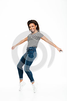 Full length portrait of a happy carefree african girl jumping