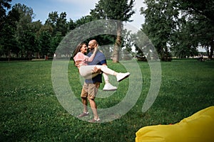 Full length portrait of happy couple embracing in the garden. Loving couple hugging outdoors.