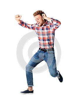 Full length portrait of happy handsome man jumping on white