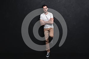 Full length portrait of happy handsome young man isolated on black background.