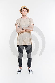 Full length portrait of happy man standing with arms crossed