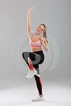 Full length portrait of a happy pretty sportsgirl