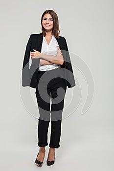 Full length portrait of a happy pretty woman in suit