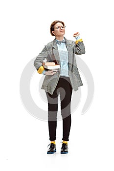 Full length portrait of a happy smiling female student holding books isolated on white background