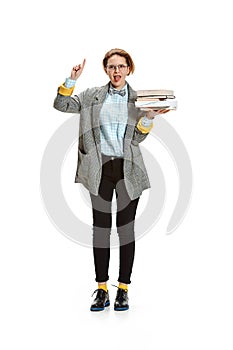 Full length portrait of a happy smiling female student holding books isolated on white background