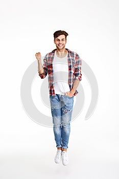 Full length portrait of a happy smiling man jumping