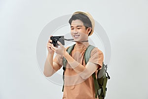 Full length portrait of happy tourist photographer man on white background. Travel blogger, tourist man