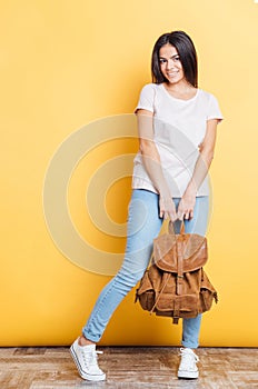 Full length portrait of a happy woman with backpack