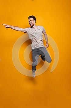 Full length portrait of a happy young man jumping