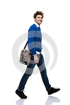 Full length portrait of a happy young man walking