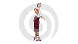 Full length portrait of a happy young woman talking on the phone on white background.