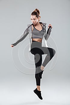 Full length portrait of a healthy woman in sportswear posing