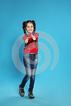 Full length portrait of little girl posing