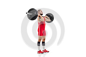 Full length portrait of man in red sportswear exercising with a weight isolated on white background. Sport