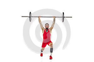 Full length portrait of man in red sportswear exercising with a weight isolated on white background. Sport