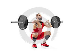 Full length portrait of man in red sportswear exercising with a weight isolated on white background. Sport