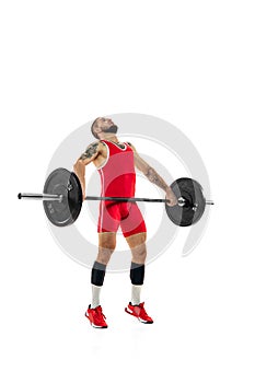 Full length portrait of man in red sportswear exercising with a weight isolated on white background. Sport