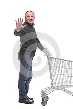 Full length portrait of a man returning an empty shopping cart