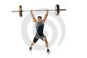 Full length portrait of a man in sportswear exercising with a weight isolated on white background