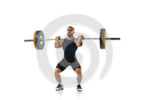 Full length portrait of a man in sportswear exercising with a weight isolated on white background