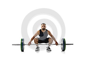 Full length portrait of a man in sportswear exercising with a weight isolated on white background