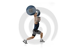 Full length portrait of a man in sportswear exercising with a weight isolated on white background