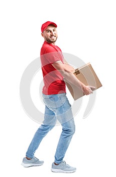 Full length portrait of man in uniform carrying carton box