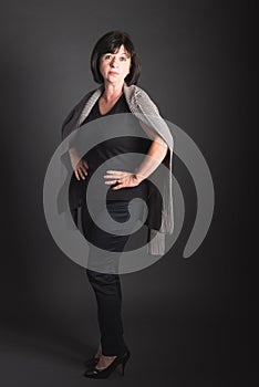 Full Length Portrait Mature Dark-Haired Woman with a Serious Expression