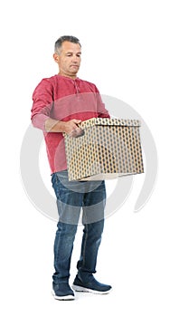 Full length portrait of mature man carrying carton box
