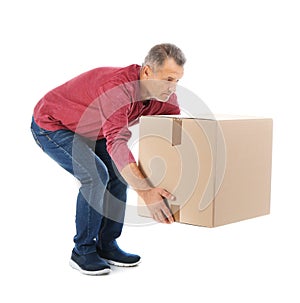 Full length portrait of mature man lifting carton box