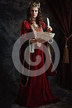 Full length portrait of medieval queen in red dress