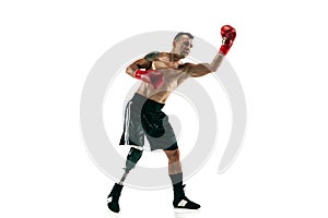 Full length portrait of muscular sportsman with prosthetic leg, copy space. Male boxer in red gloves.