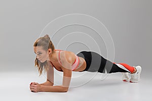 Full length portrait of a pretty fit sportsgirl doing plank