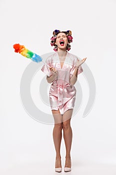 Full length portrait of a pretty housewife with curlers