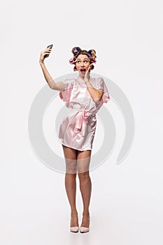 Full length portrait of a pretty housewife with curlers