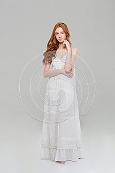 Full length portrait of a pretty redhead woman in dress
