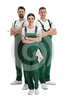 Full length portrait of professional auto mechanics on background