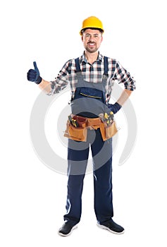 Full length portrait of professional construction worker with tool belt on white