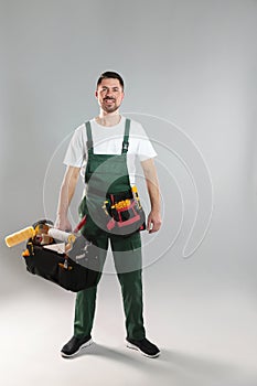 Full length portrait of professional construction worker with tools