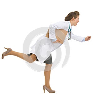 Full length portrait of running doctor woman