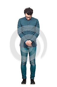 Full length portrait of sad businessman looking down ashamed, feels guilty and has remorse isolated on white background. Upset